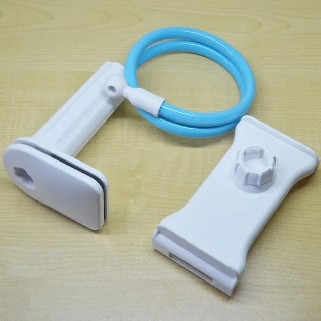 Black bedside phone handset with a long aluminium arm holding a mobile phone on a table.