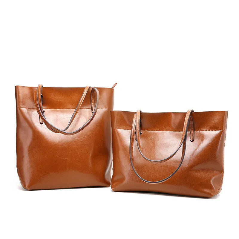 Horizontal brown cowhide leather crossbody handbag showing two main compartments and a front pocket.