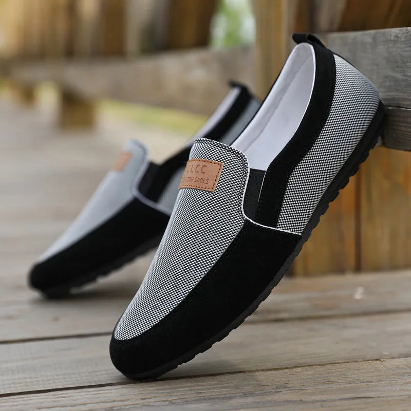 Men's grey and khaki canvas slip-on board shoes with round toe and rubber sole.