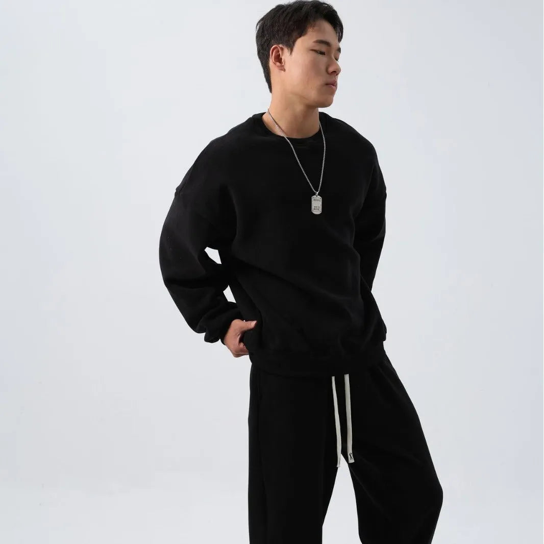 Men's polar fleece sports suit showing long-sleeved top and padded trousers in light grey colour