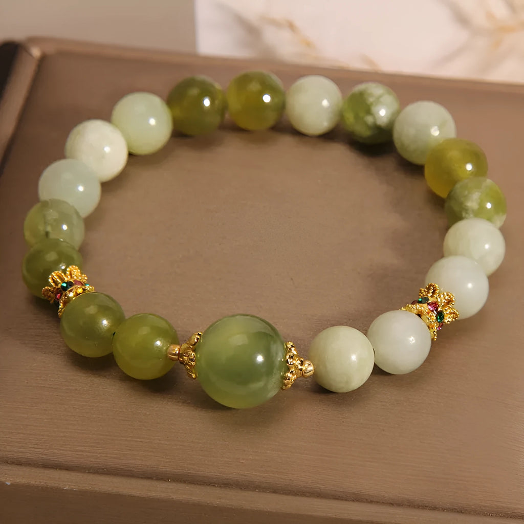 Women's solid Xiuyan jade bracelet in a green colour, shown as a single smooth bead.