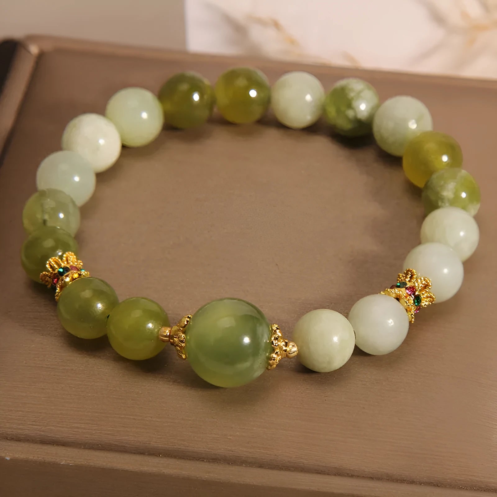 Women's solid Xiuyan jade bracelet in a green colour, shown as a single smooth bead.