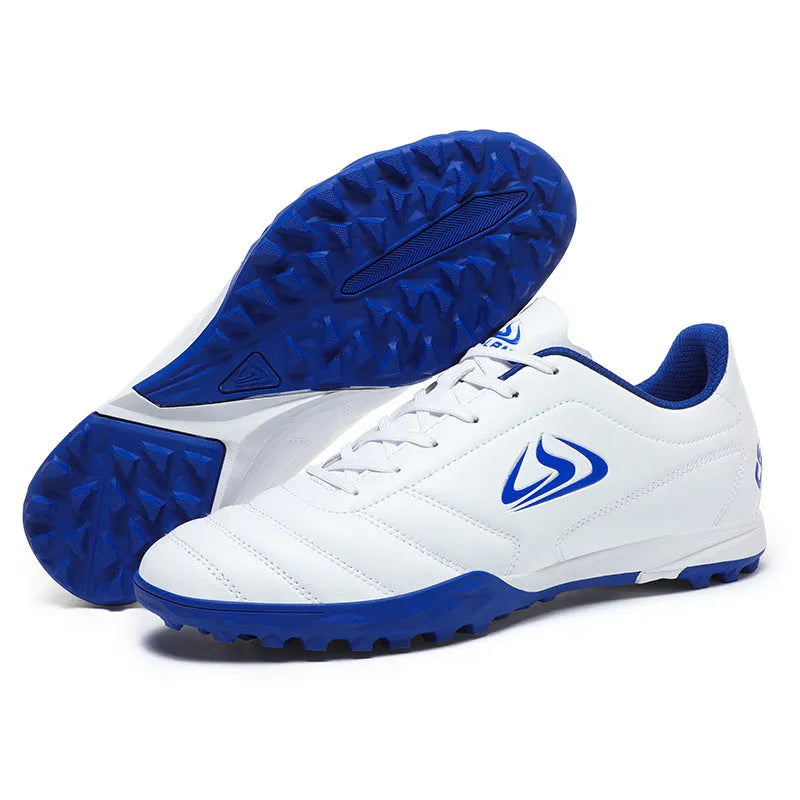 Low-top turf soccer shoes in black and white broken nails colour with synthetic leather upper