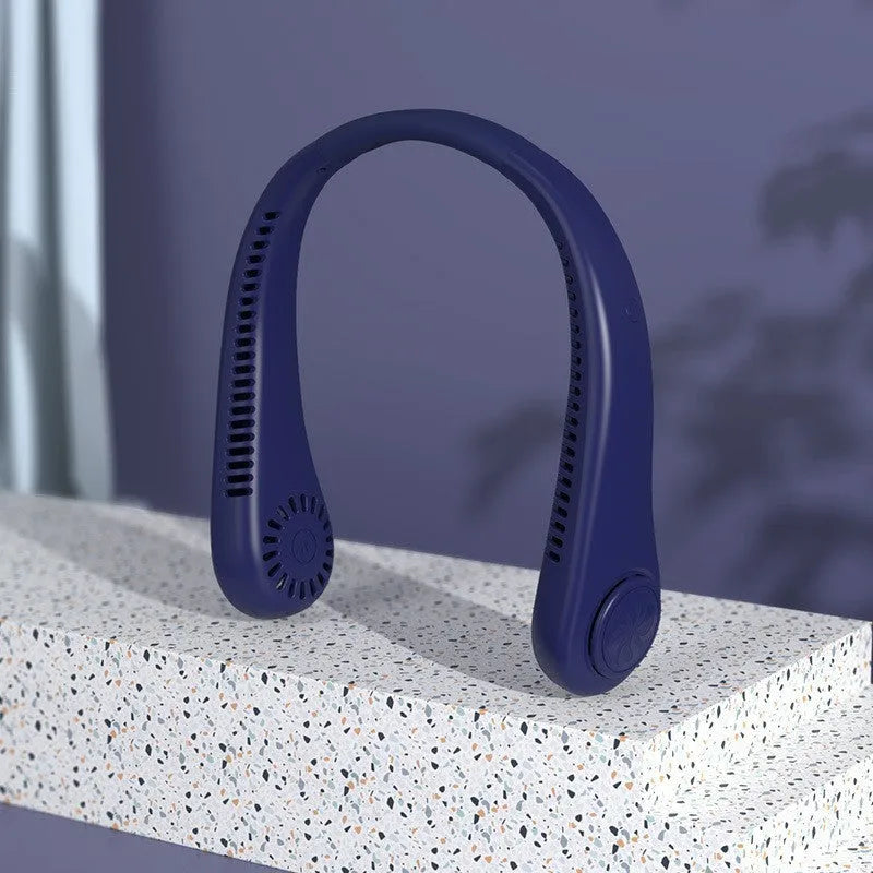 White portable bladeless neck fan hanging around a person's neck showing its USB charging port.