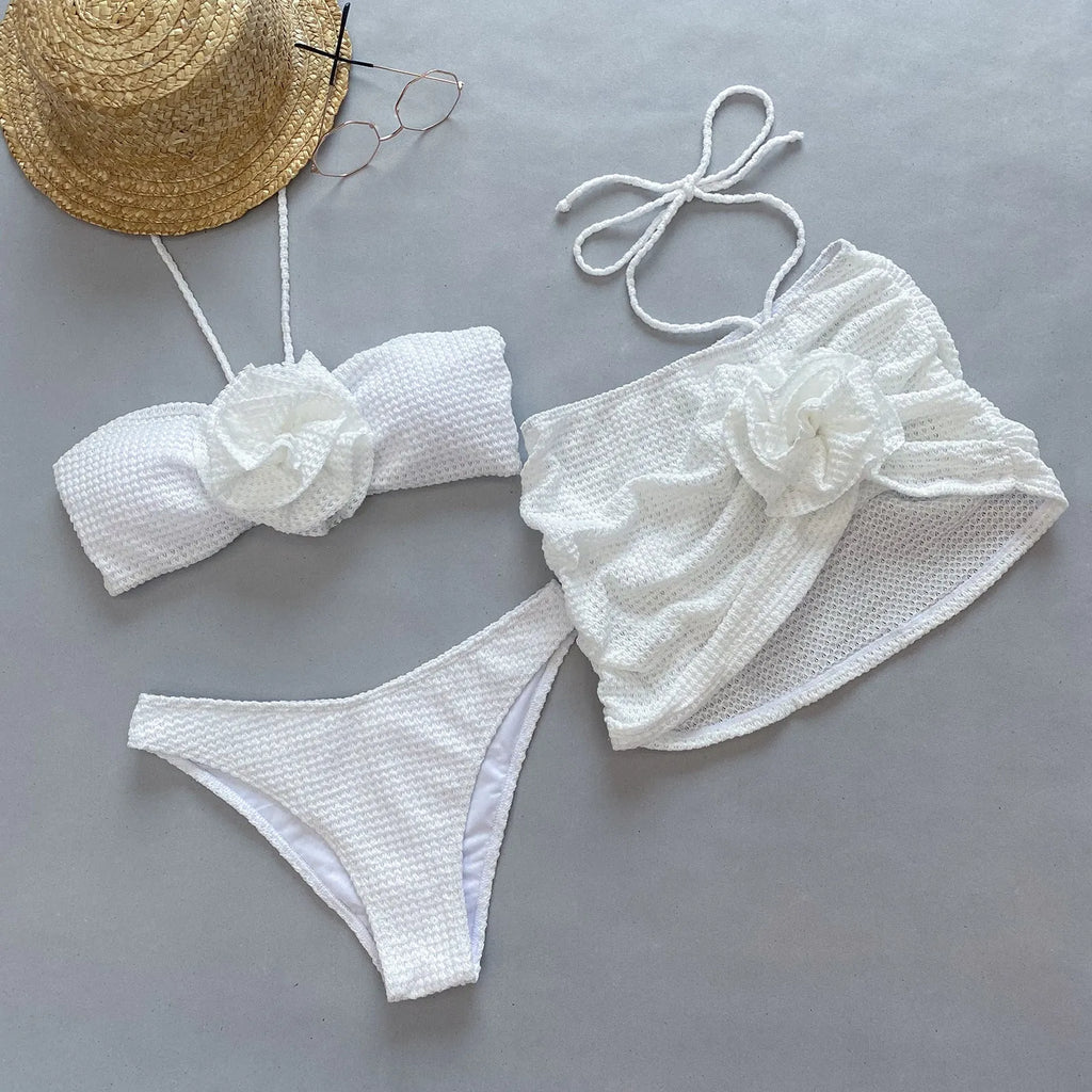 Women's white and purple 3D flower split three-piece bikini set with skirt, bra, and briefs.