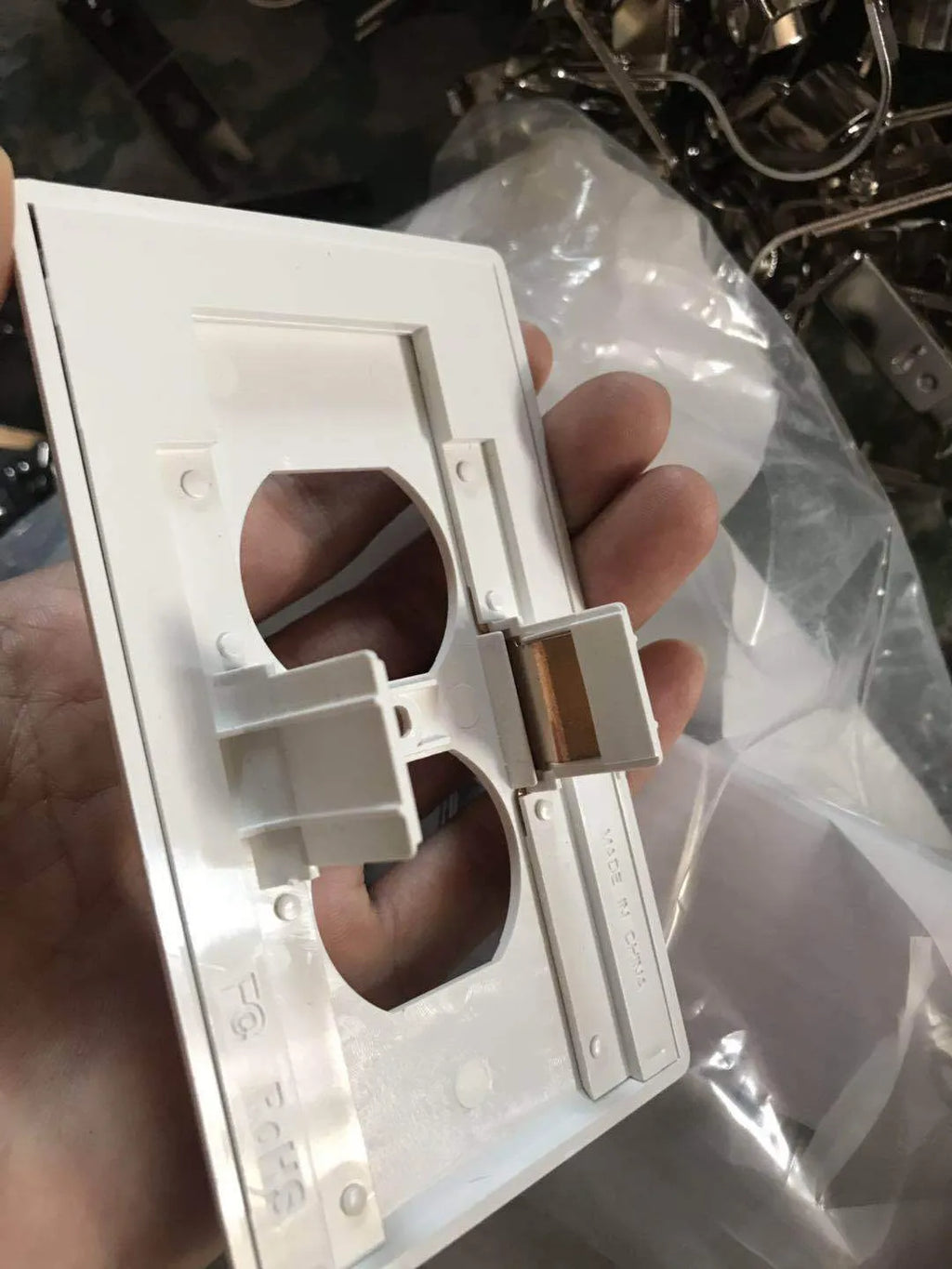 White plastic LED night light plugged into a standard UK wall socket.
