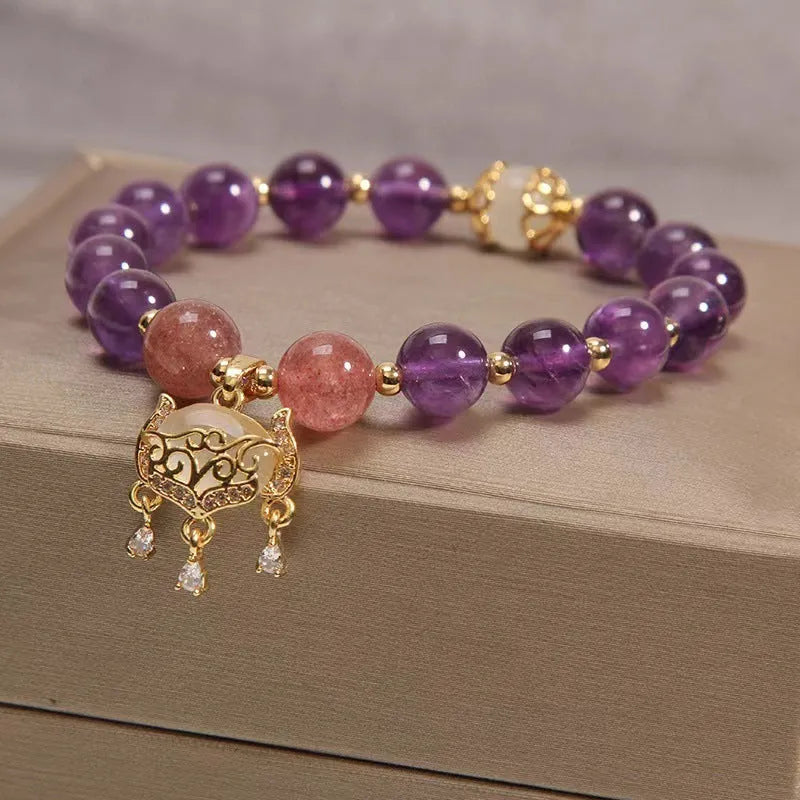 Handmade copper bracelet for women with a natural amethyst drop charm and longevity lock symbol.