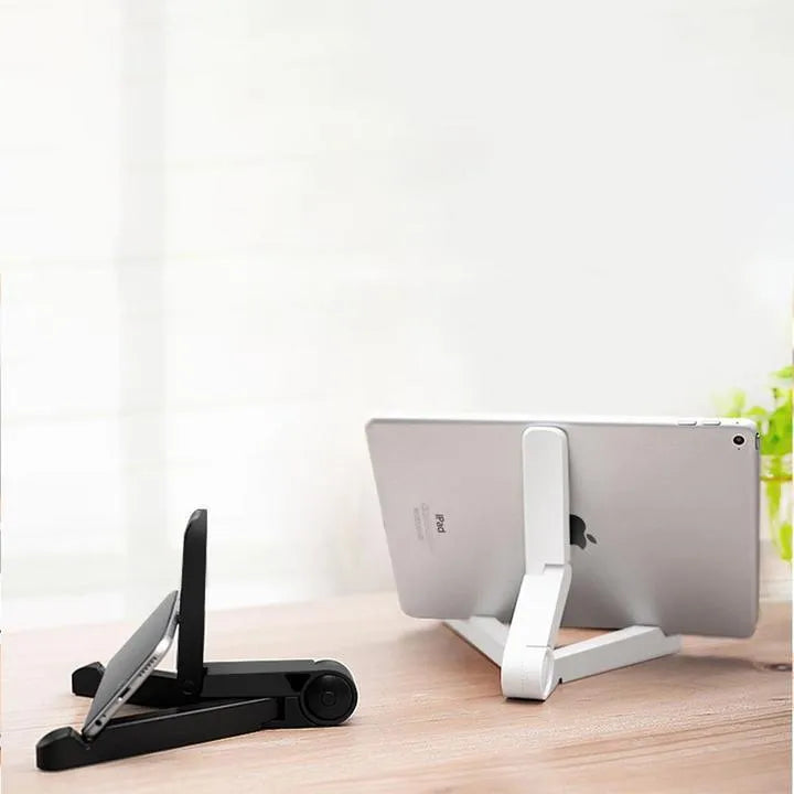 Black foldable tablet holder displaying adjustable angles with phone in landscape mode on non-slip surface
