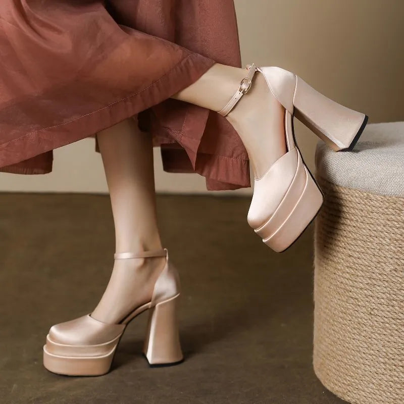 Women's white chunky heel platform pumps with a round toe and waterproof upper on a rubber sole.
