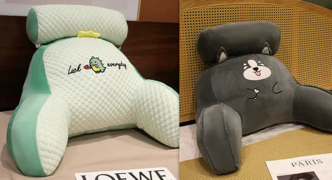 Grey triangle-shaped reading pillow with embroidery on a chair, showing its ergonomic back support shape.