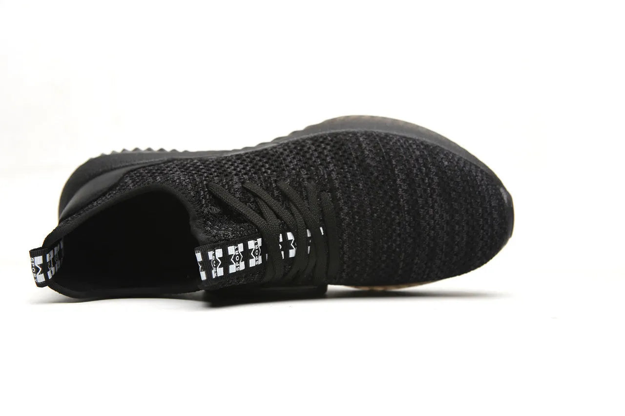 Low-cut black safety shoes with a steel toe cap on a plain background.