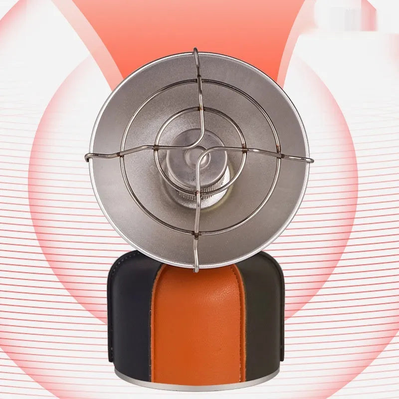 Black and orange portable outdoor heating stove with automatic ignition on a table.
