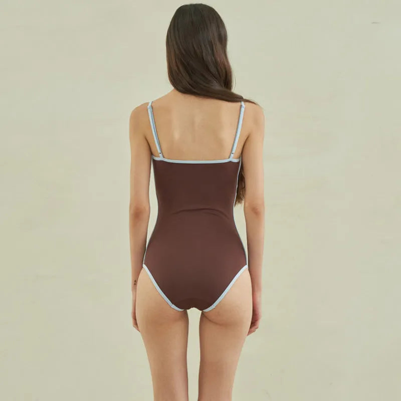 Brown triangle style one-piece swimsuit for women on a hanger