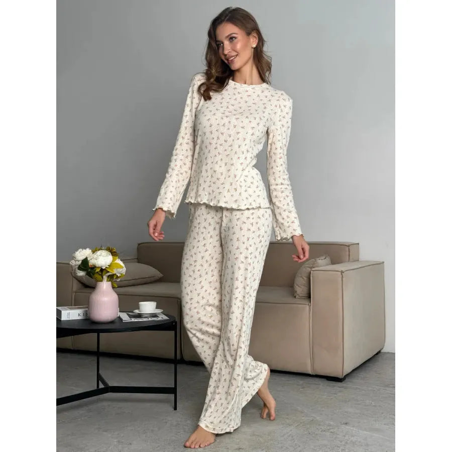 White floral print women's suit with bell sleeve top and wide leg trousers on hanger