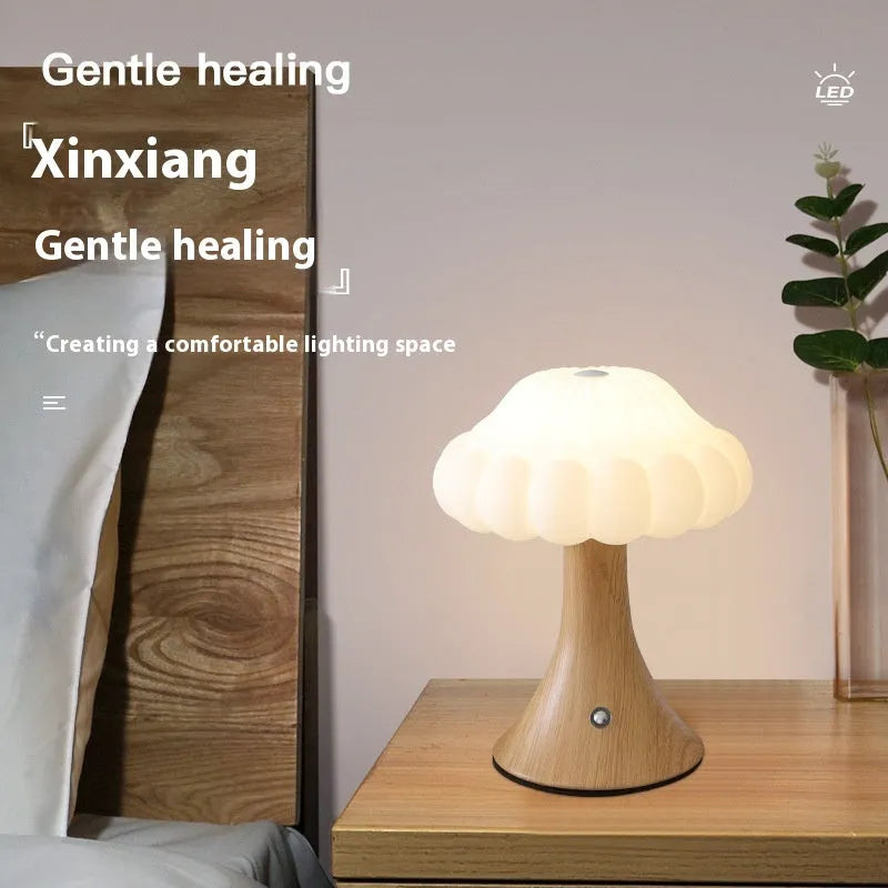 Mushroom-shaped touch control table lamp with USB charging port in wood grain colour.
