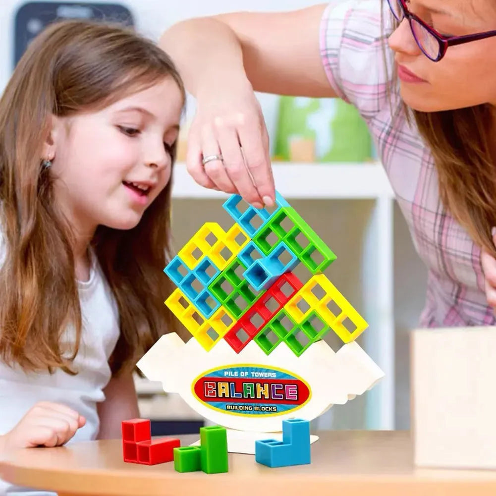 Plastic balance stacking board game with 16 colourful blocks, chassis, and base on a table.