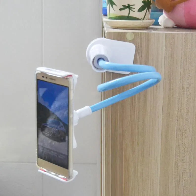 Black bedside phone handset with a long aluminium arm holding a mobile phone on a table.