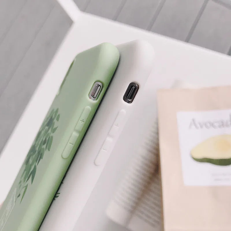 White silicone iPhone case with painted plant design showing 360-degree edge protection