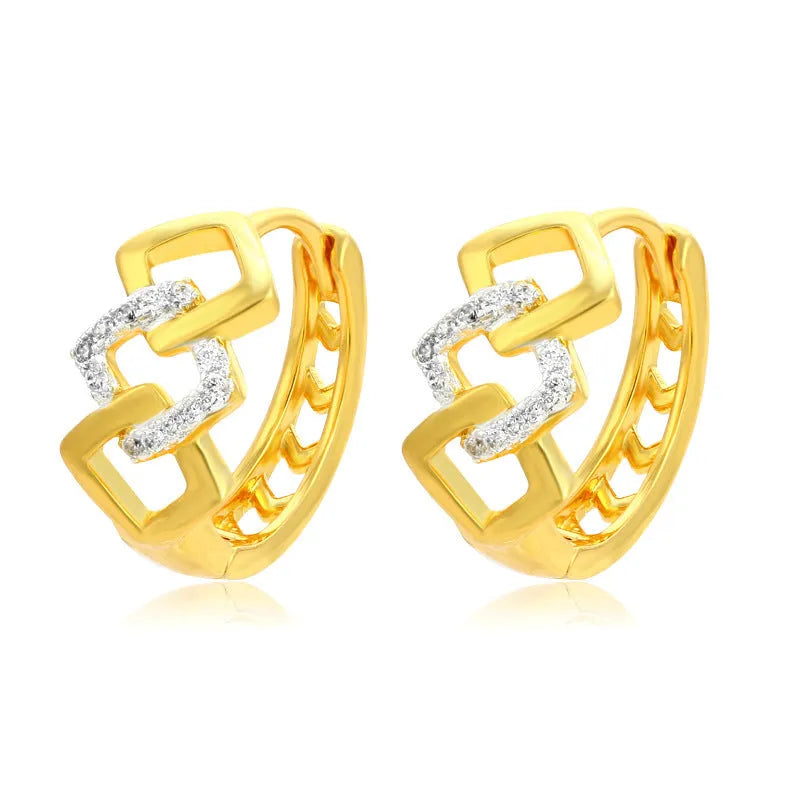 A pair of gold-coloured geometric drop earrings with a hollow out design on a plain background.