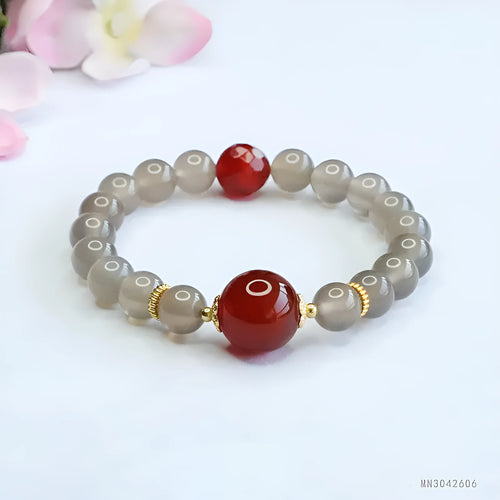 Smoky purple and red agate bracelet with 8mm geometric beads on a wrist.