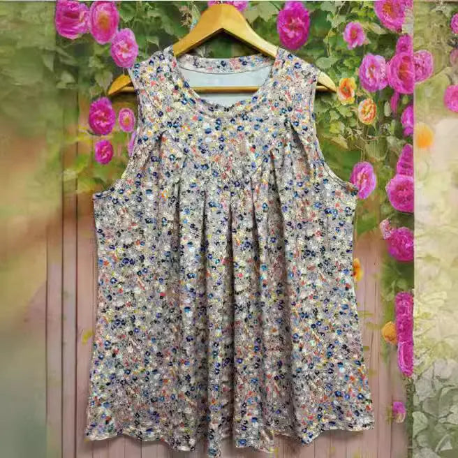 Black floral print sleeveless vest on a hanger, showing loose fit and round neck for plus sizes.
