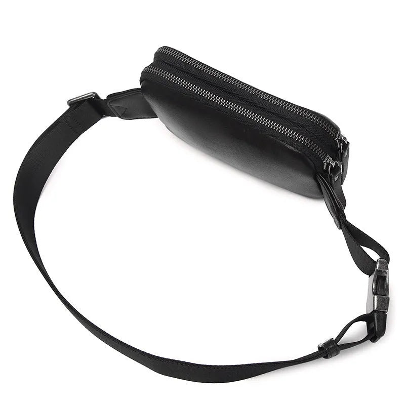 Men's small black leather crossbody bag showing compact size and crossbody strap.