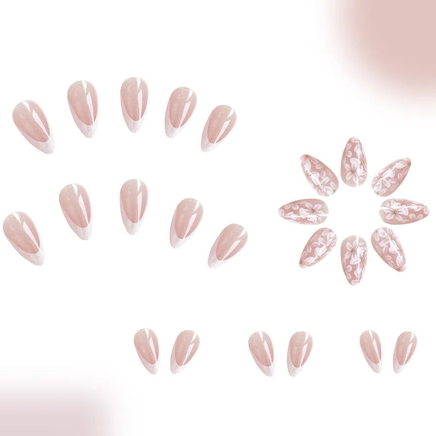 Short glossy almond artificial nails with French tip and glitter flower decorations