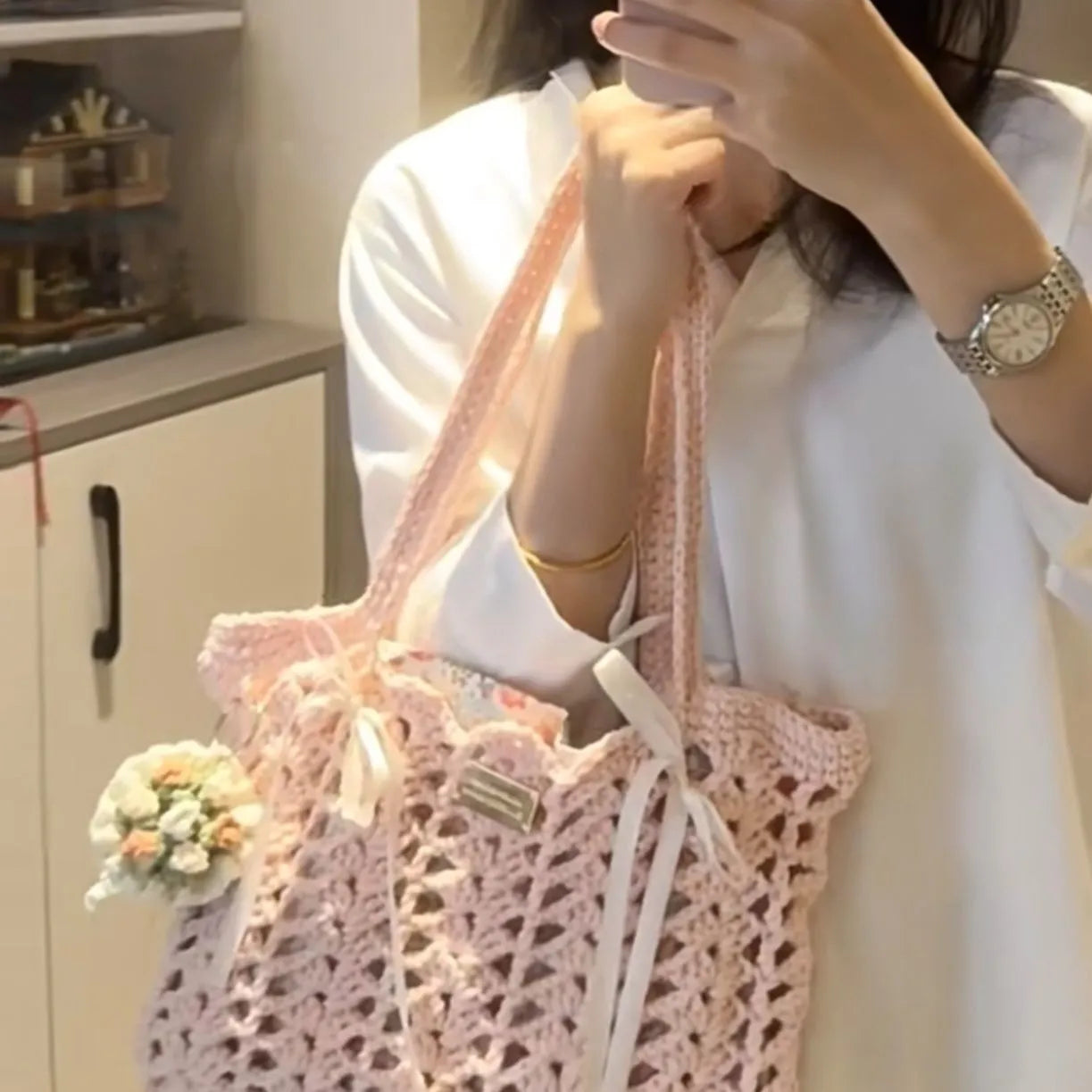 Handmade woven shoulder bag with a floral pattern, made from soft wool yarn.