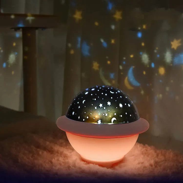 Green UFO shaped starry sky projection night light on a surface showing star projection.