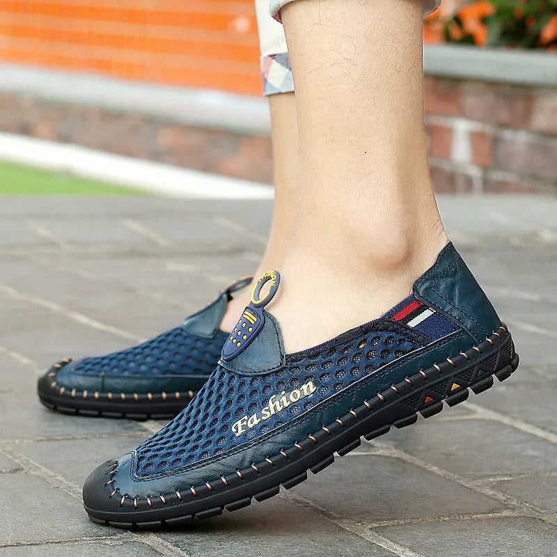 Men's brown casual shoes with mesh upper and rubber sole on a light background.