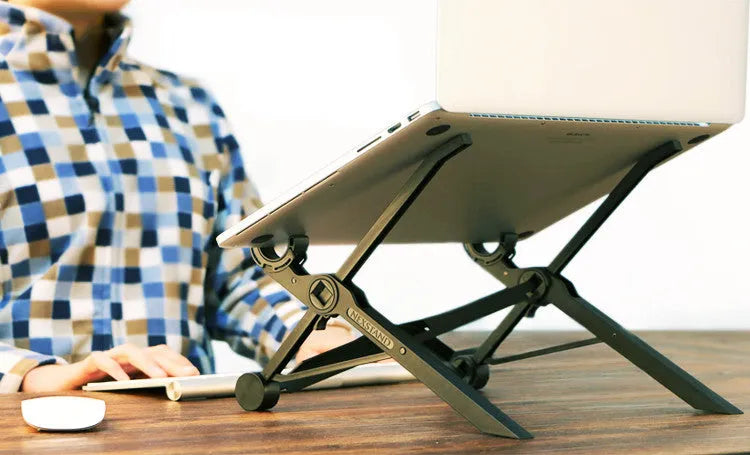Black folding portable laptop stand made of reinforced nylon, shown folded to its compact size.
