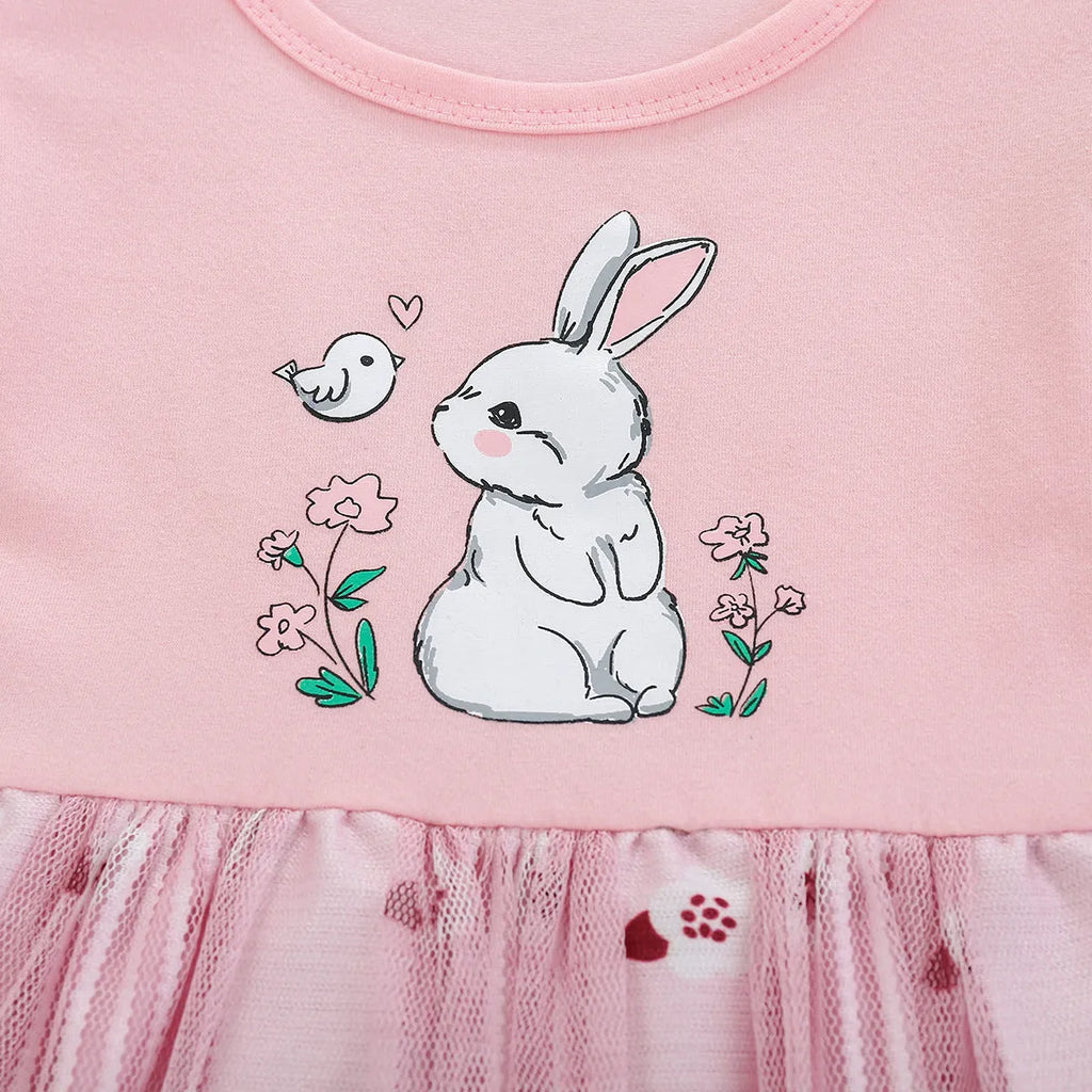 Pink cotton girls princess dress with cartoon rabbit print and mesh overlay on plain background
