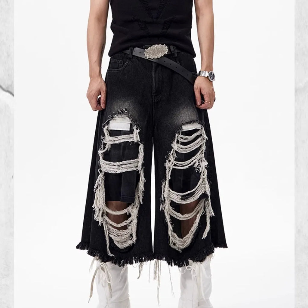 Black cropped wide-leg jeans with mid-high waist and distressed patch detail on micro-elastic denim