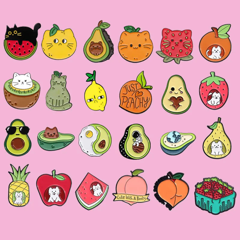 Colourful cartoon fruit design metal brooch pin on a fabric background.