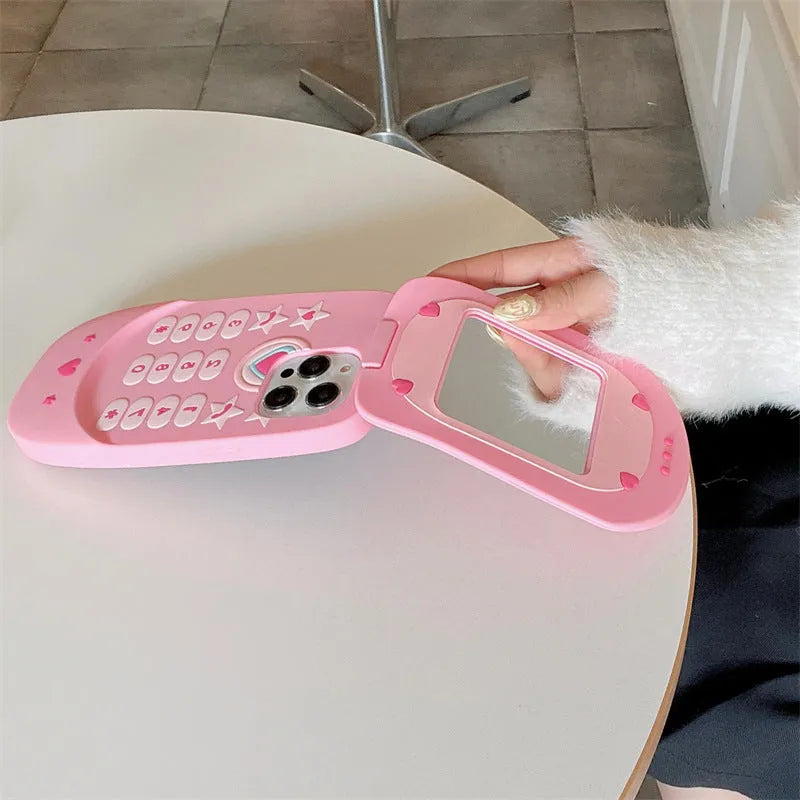 Light pink silicone iPhone case with a built-in cosmetic mirror, showing a cute cartoon design.
