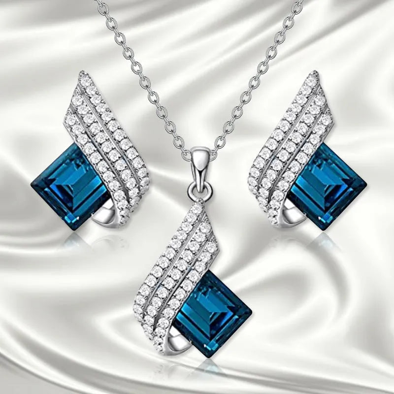 Women's electroplated necklace and earring set with alloy pendant and glass accents on cross chain
