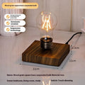 Small black suspension bulb night lamp with iron art body on a wood grain base for desktop decoration.