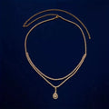 Gold rhinestone waist chain with water drop pendant and tassel on white background