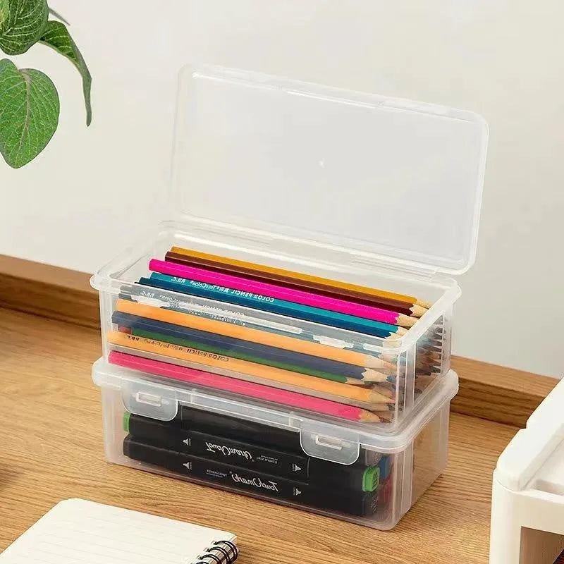 Transparent plastic pencil storage box showing organised drawing tools inside