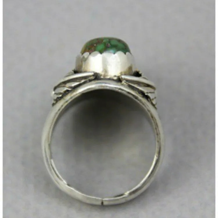 Women's geometric alloy ring with a turquoise coloured inlay, shown on a model's finger.