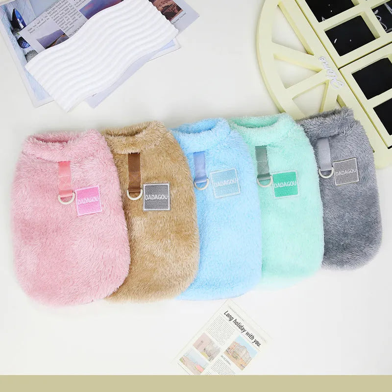 A blue coral fleece pet jacket for dogs or cats with a pull-ring fastening, laid flat.
