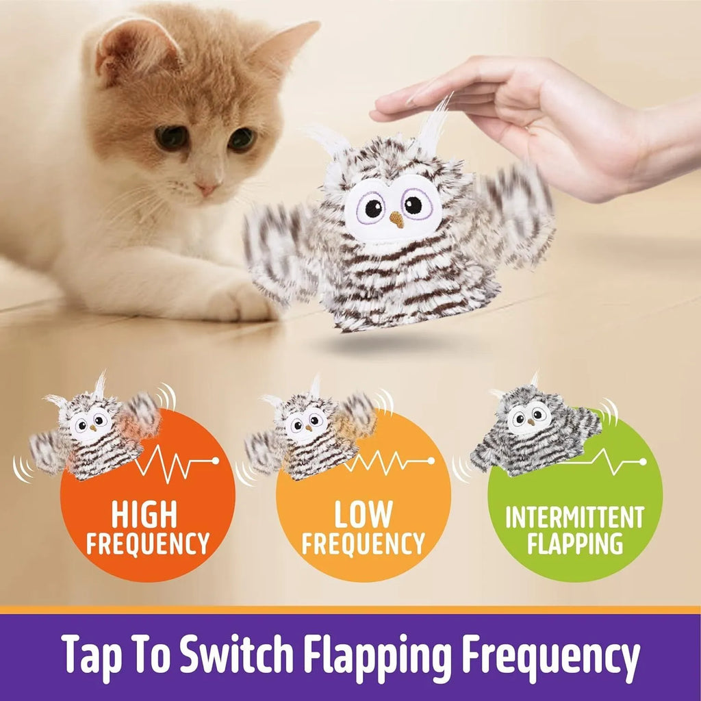 Grey owl-shaped automatic cat toy with flapping wings on flat surface
