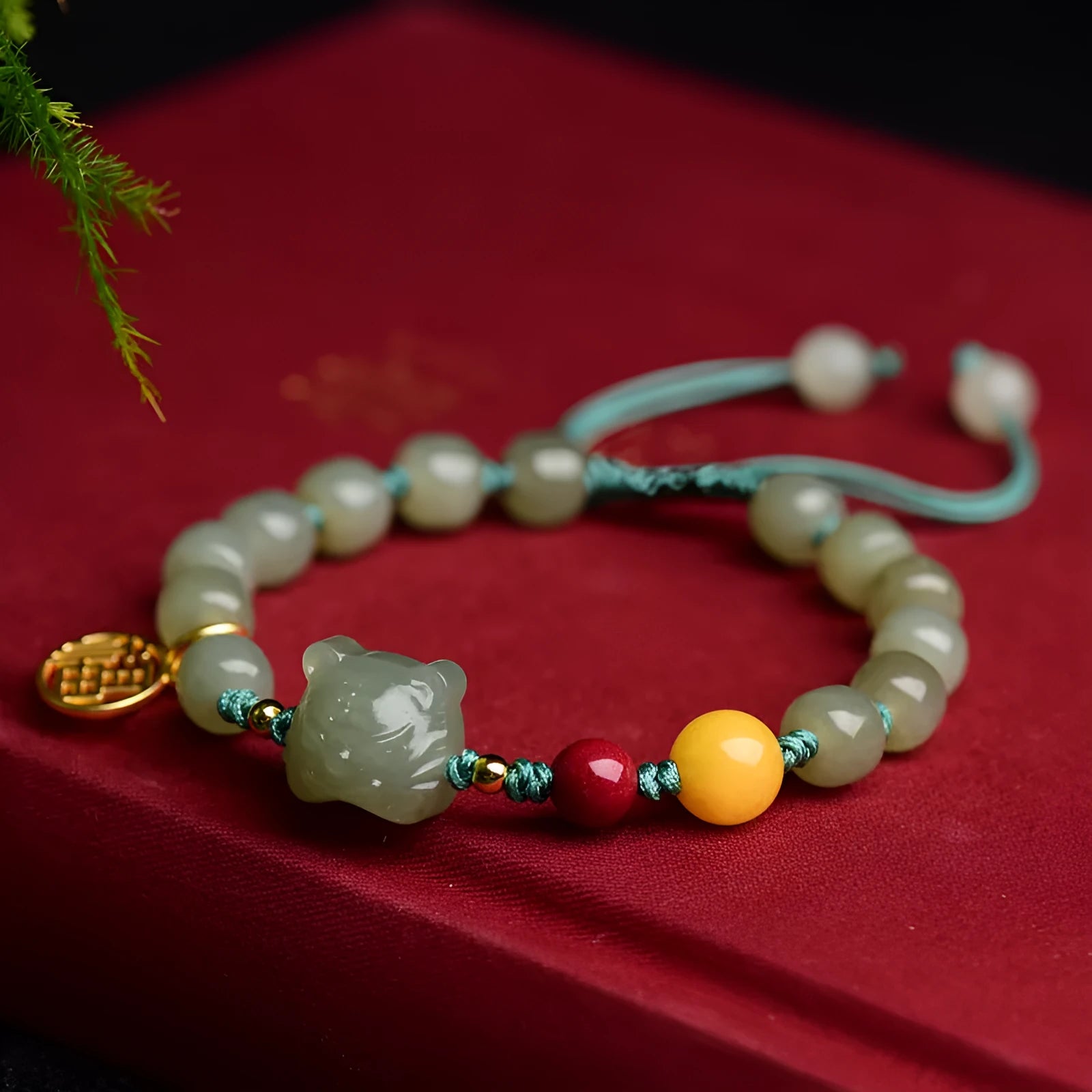 Natural Hetian Jade bracelet with cinnabar and beeswax beads, showing Zodiac modelling on 5x7mm beads.