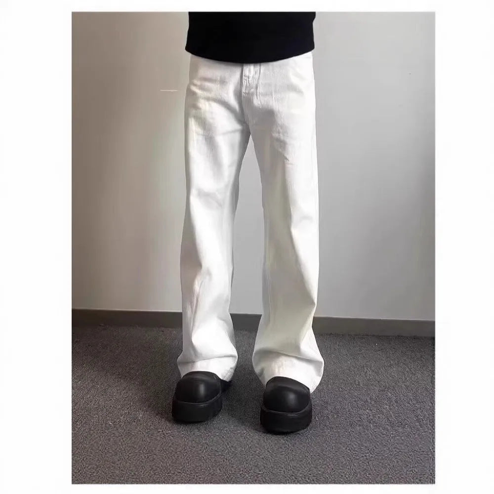 Men's loose fit straight wide leg white cotton denim jeans on a mid waist, showing zipper fly.