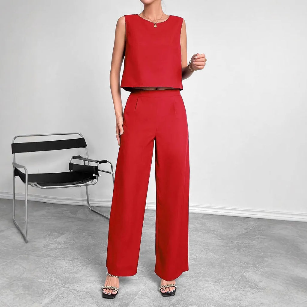 Women's red polyester two-piece set with sleeveless round-neck top and wide-leg trousers laid flat.