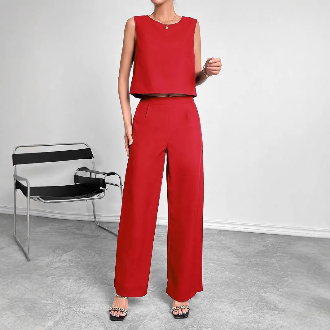 Women's red polyester two-piece set with sleeveless round-neck top and wide-leg trousers laid flat.