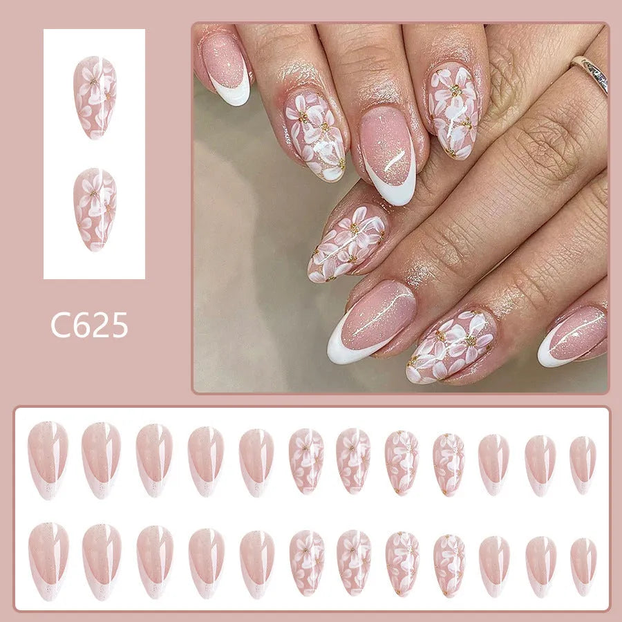 Short glossy almond artificial nails with French tip and glitter flower decorations