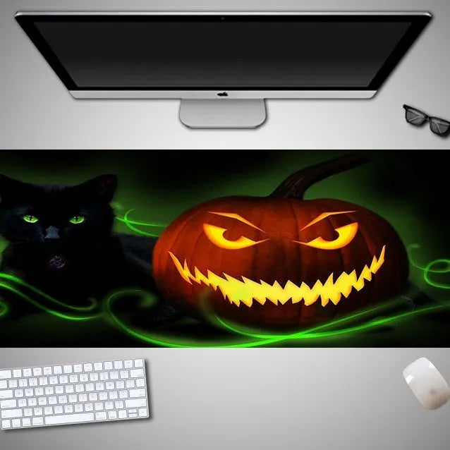 Oversized Halloween-themed rubber cloth gaming mouse pad on a desk.