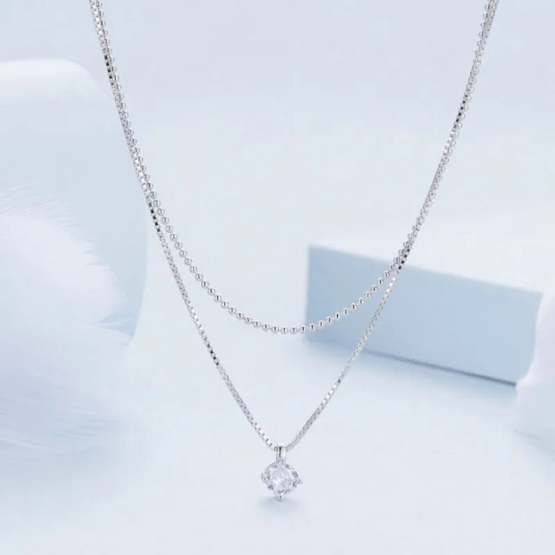 S925 sterling silver double layer necklace with pearl chain and silver alloy pendant.