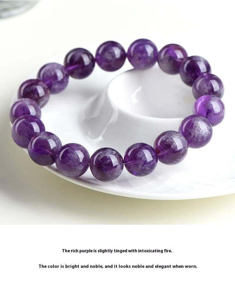 Natural purple feather amethyst crystal bracelet with geometric Ruyi design and scattered beads.